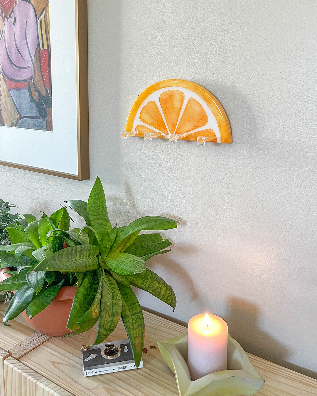 Decorative and practical orange design key holder, blending art with utility for wall organization